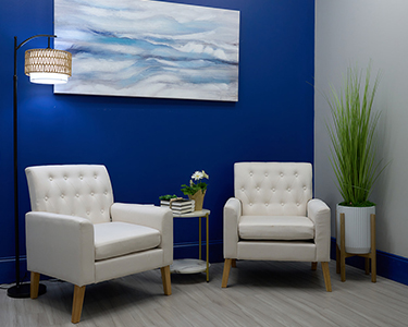 BoldAge PACE North Charleston, SC lounge with two chairs and blue wall