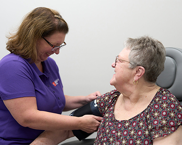 BoldAge PACE North Charleston, SC Medical Care — staff member checking blood pressure